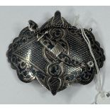 Silver: A Russian Cossack silver niello belt buckle with dagger pin on a chain, c.1900, stamped to