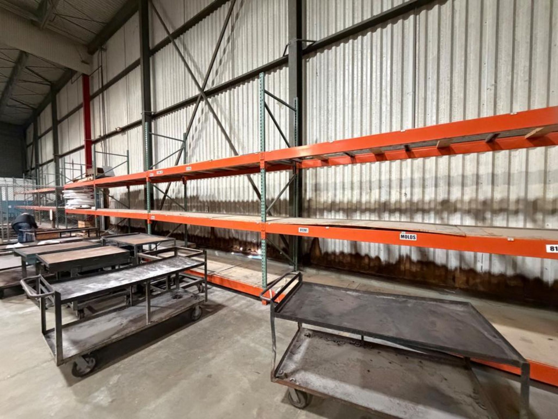 This lot includes seven sections of pallet racking, each standing 12 ...