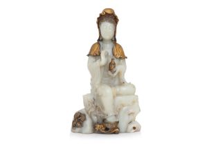 A CARVED AND GILT JADE MODEL OF GUANYIN