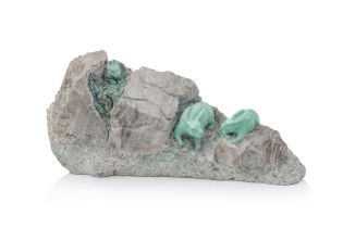 A TURQUOISE BOULDER CARVING OF RABBITS