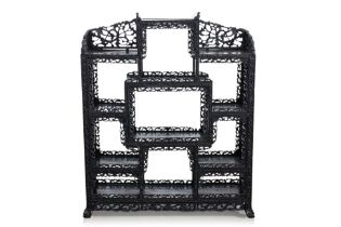 A CARVED BLACKWOOD DISPLAY SHELF