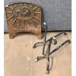 A 19th Century cast iron fire back, a fire surround and pair of andirons