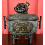 A Japanese Meiji period enamelled bronze incense burner, depicting fighting dogs of foe and floral