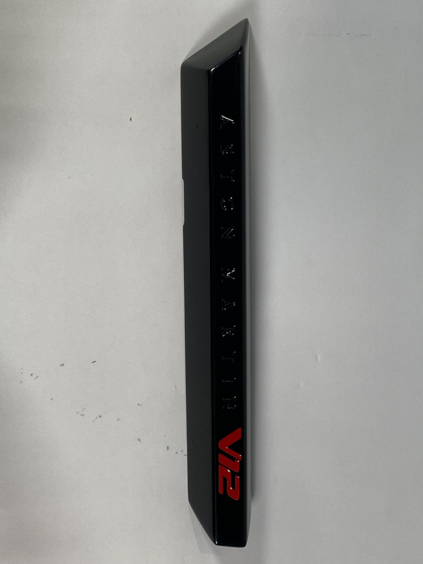 A gloss black left hand side strake assembly kit for a 2025 Aston Martin Vanquish Super GT V12.