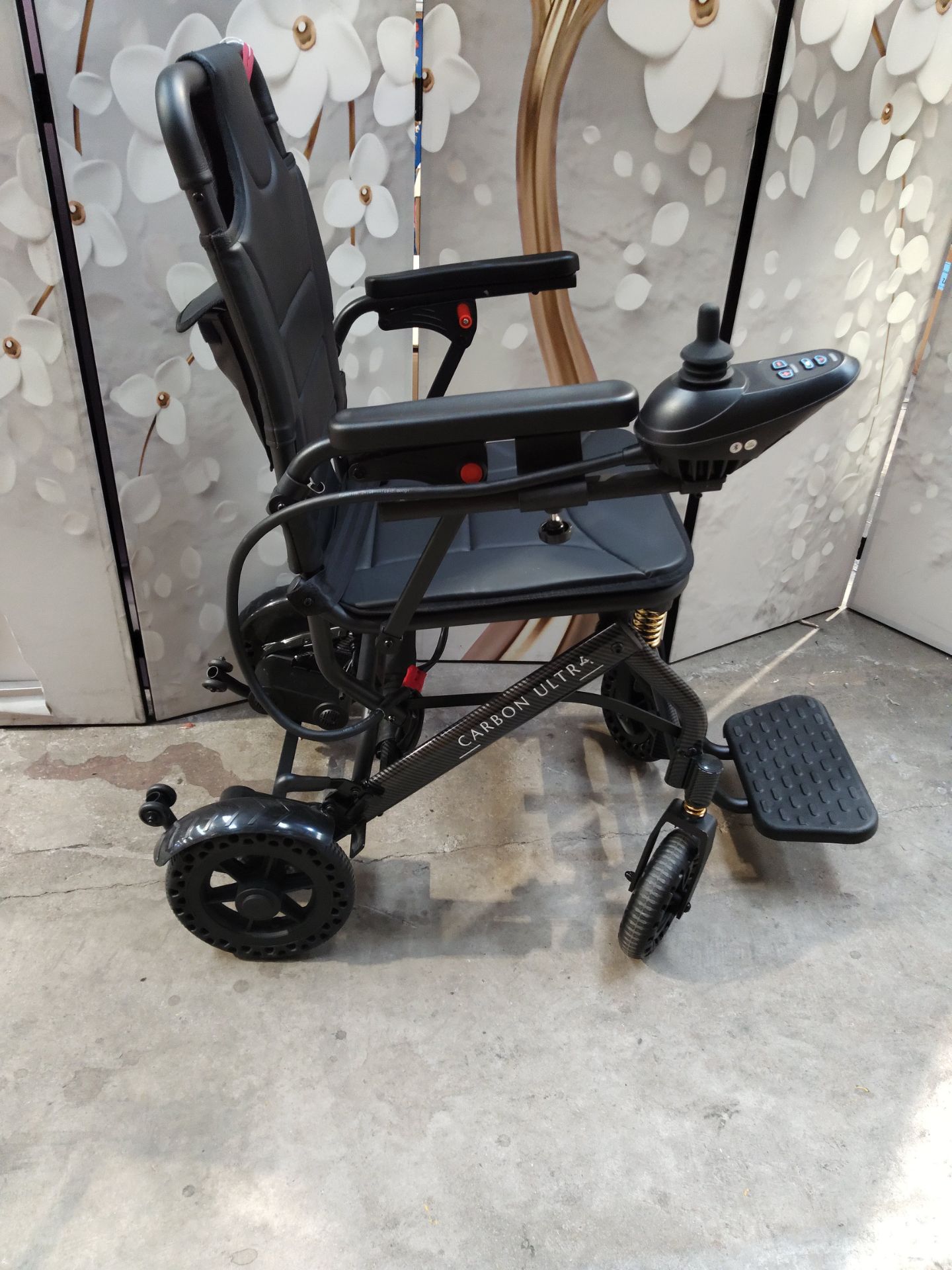 An as new carbon fibre lightweight foldable wheelchair. - Image 2 of 3