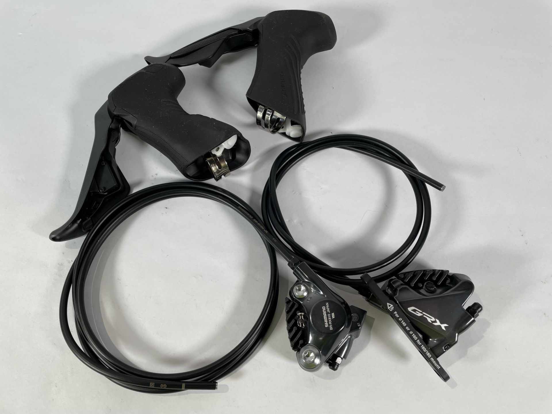 Two Shimano BR-RX810 Japan Callipers and two Shimano GRX brake levers (R, L).