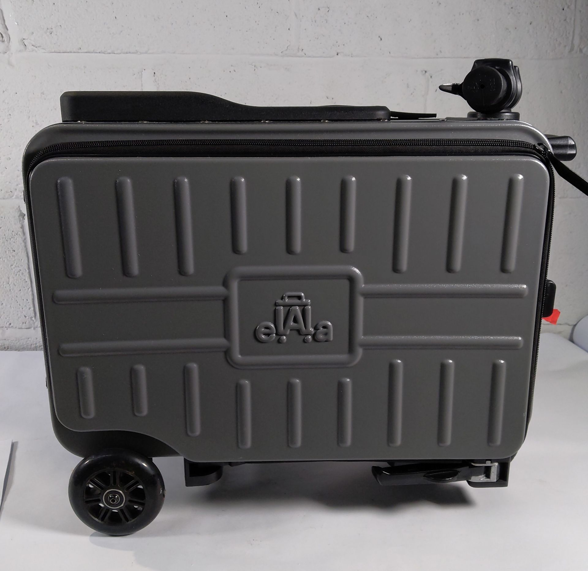 A pre-owned Elela ride on suitcase with battery and charger.