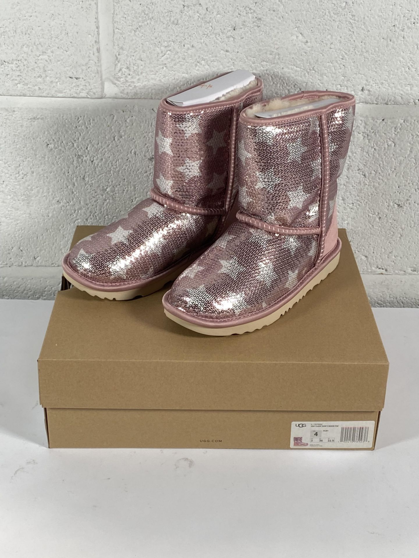 A pair of Ugg kids classic short 2 sequin star boots (UK 3).