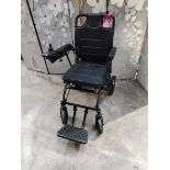 An as new carbon fibre lightweight foldable wheelchair.