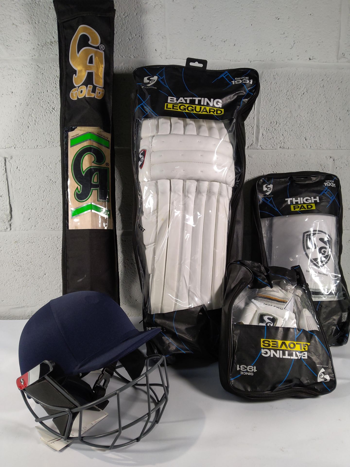 A Cricket kit to include CA SM 18 English willow cricket bat, Aero guard helmet with face guard.