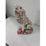 A Howling Wolf stone garden ornament.