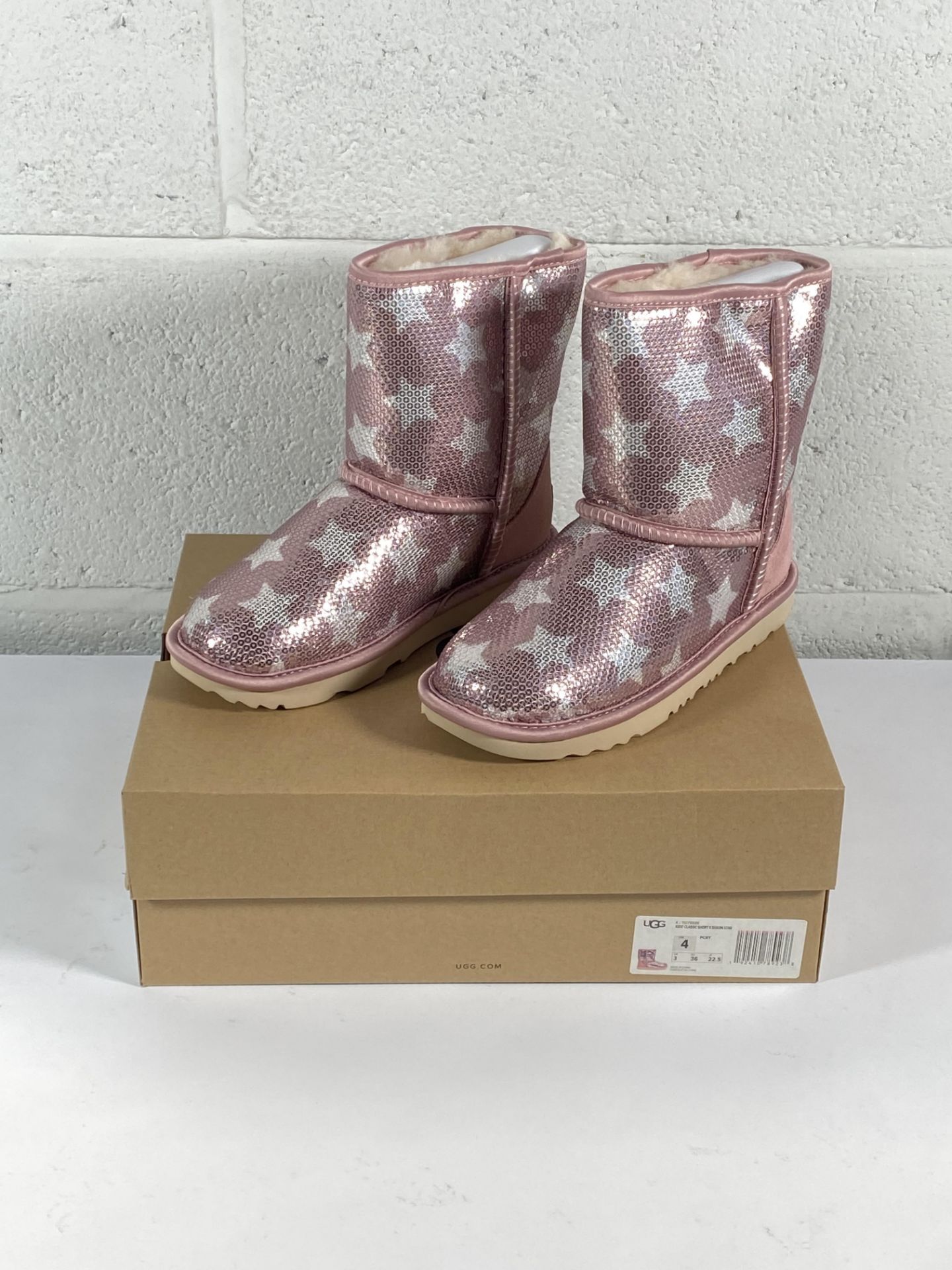 A pair of children's Ugg classic short 2 sequin star boots (UK 3).