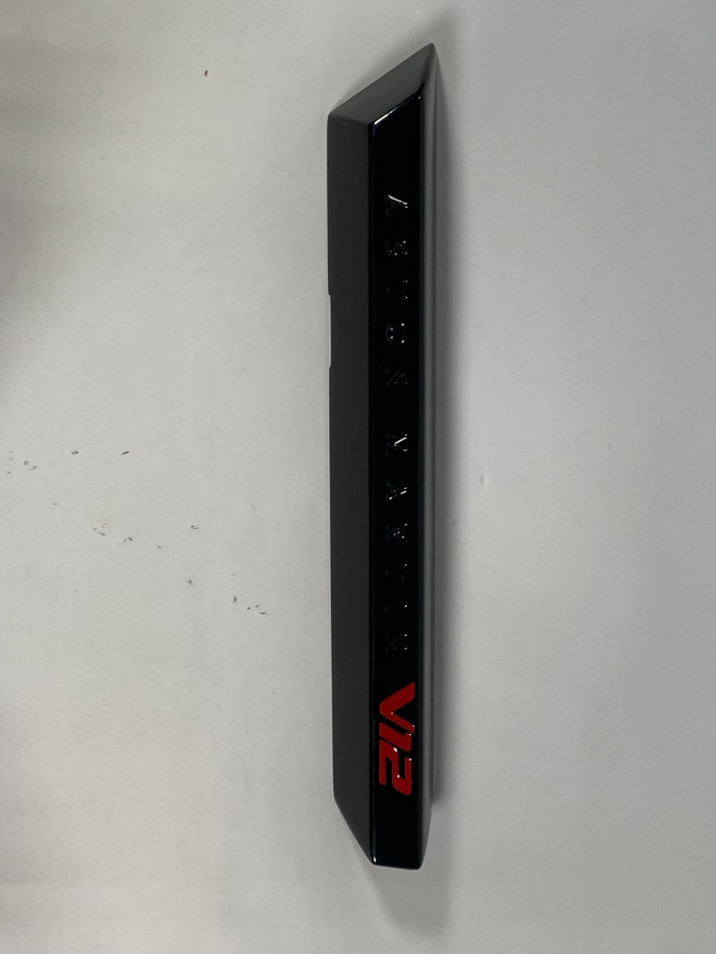 A gloss black left hand side strake assembly kit for a 2025 Aston Martin Vanquish Super GT V12.