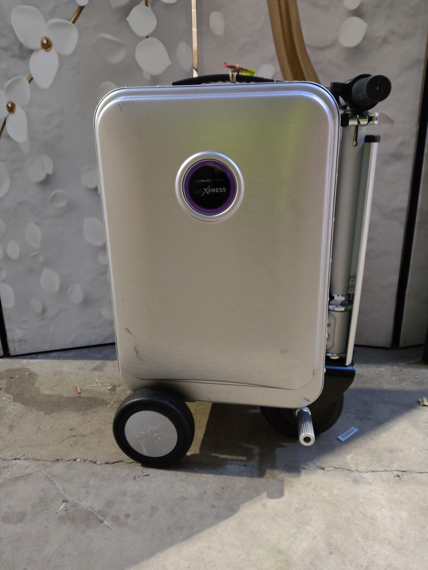 A pre-owned Air Express G45 wheeled ride on suitcase with battery.