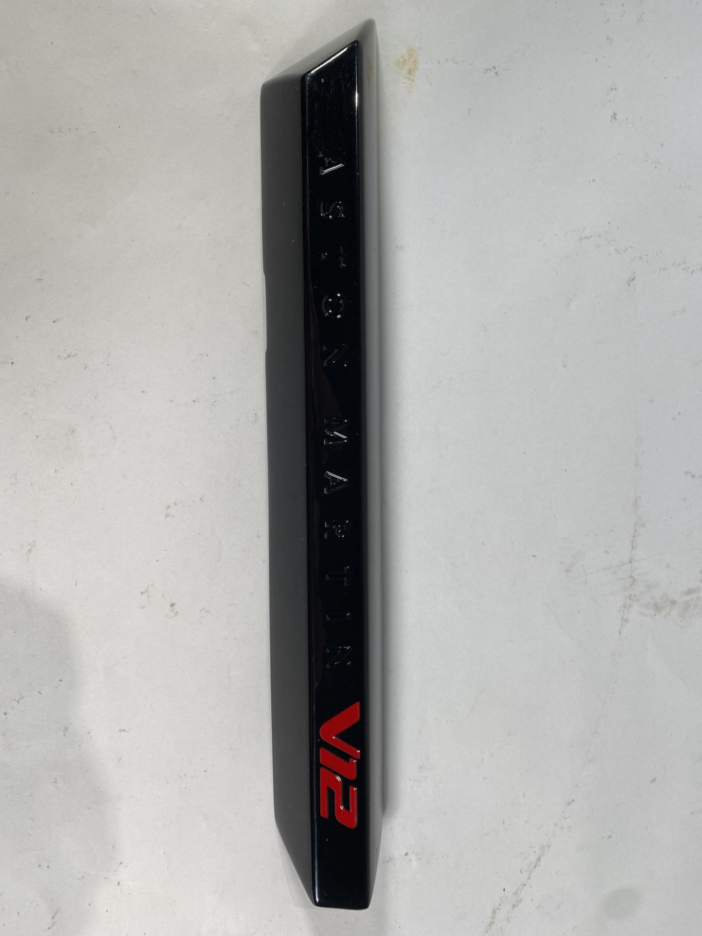 A gloss black left hand side strake assembly kit for a 2025 Aston Martin Vanquish Super GT V12.