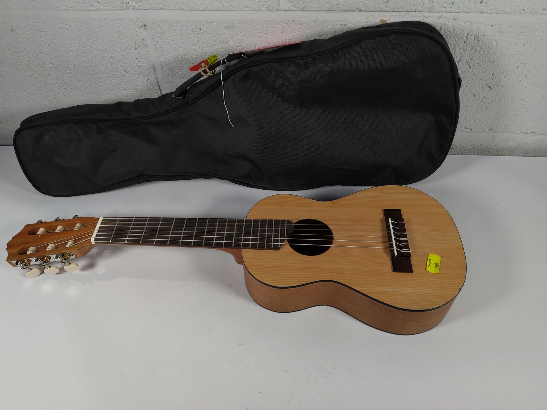 A pre-owned Yamaha Guitalele GL1 includes travel case.
