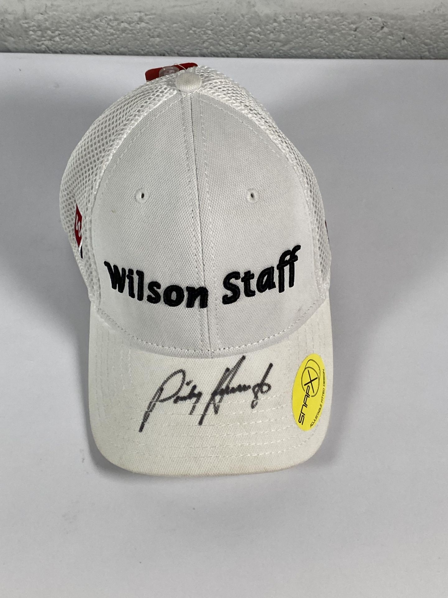 A Wilson Staff baseball cap signed by Padraig Harrington (BCVA do not guarantee authenticity of the