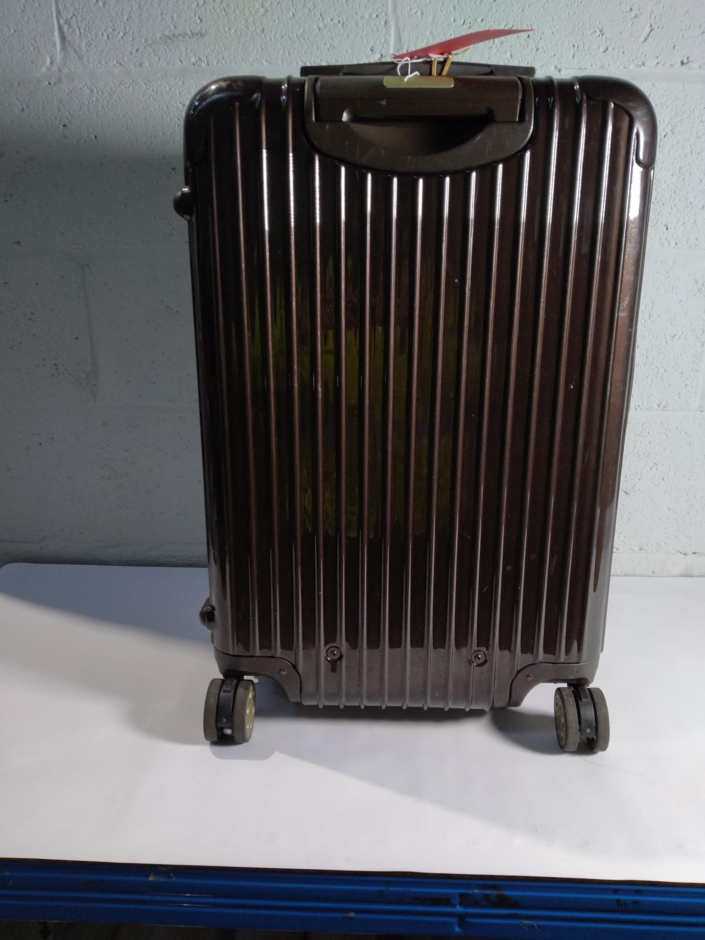 A pre-owned Rimowa polycarbonate shell wheeled suitcase. (H65 - L40).
