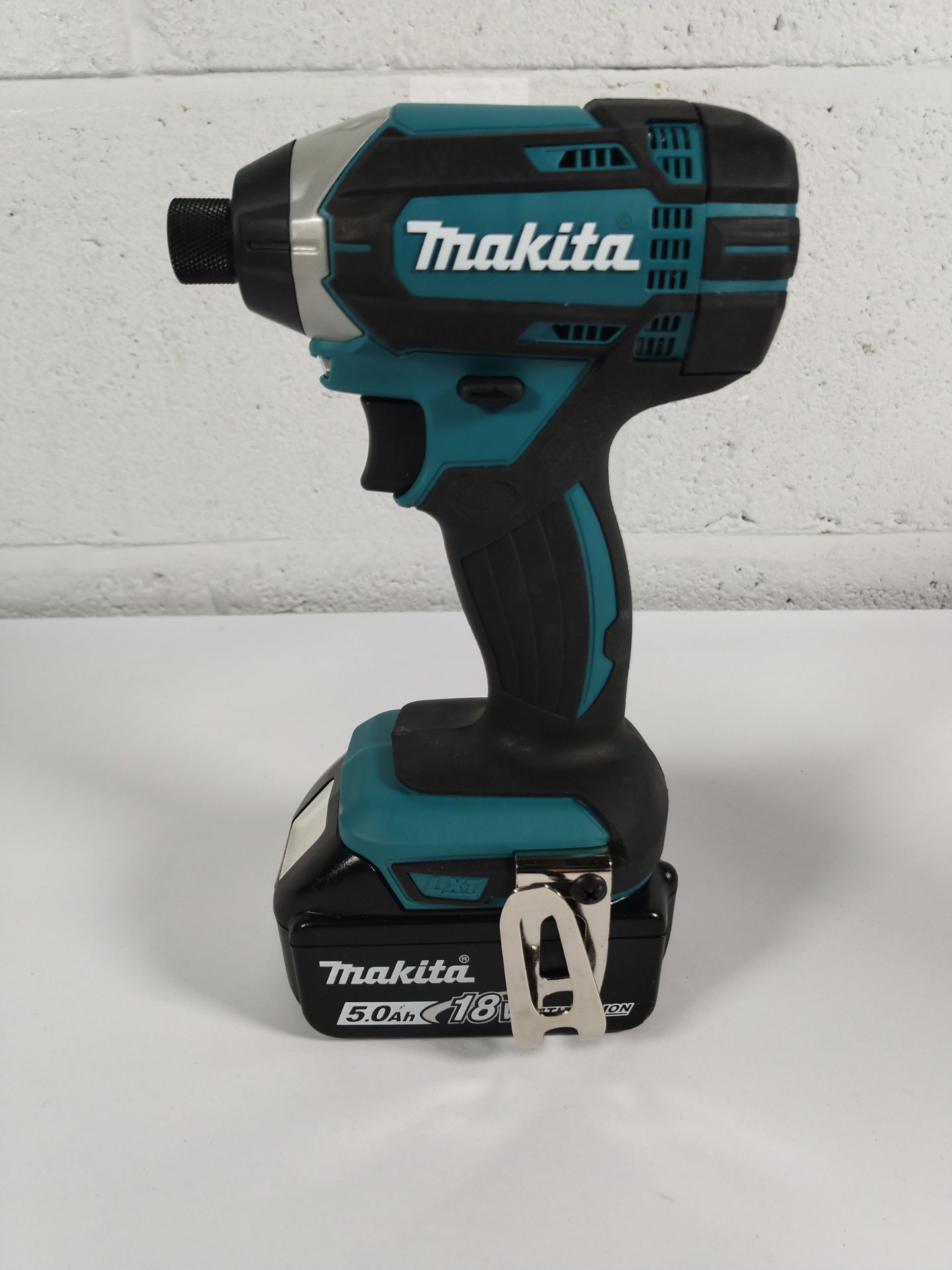 A pre-owned 2025 Makita DTD152 impact driver with battery.