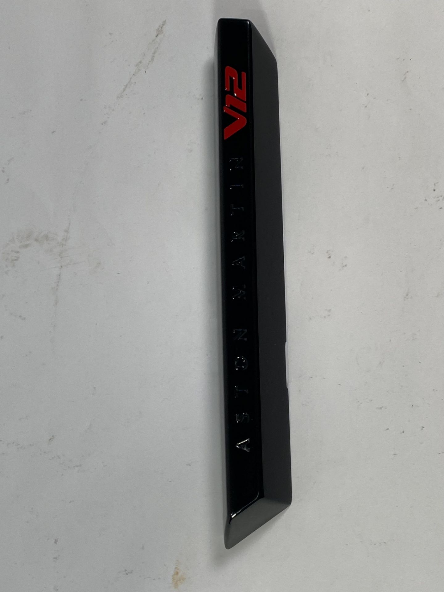 A gloss black left hand side strake assembly kit for a 2025 Aston Martin Vanquish Super GT V12.