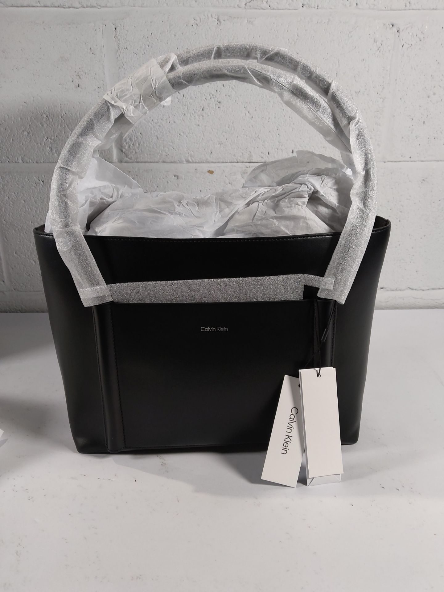 A Calvin Klein Linn medium handbag with tags.