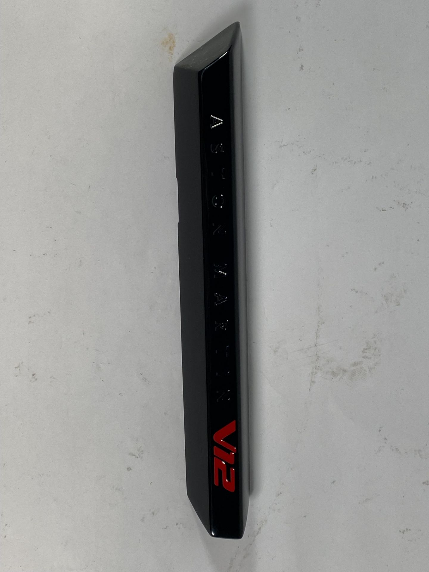 A gloss black left hand side strake assembly kit for a 2025 Aston Martin Vanquish Super GT V12.