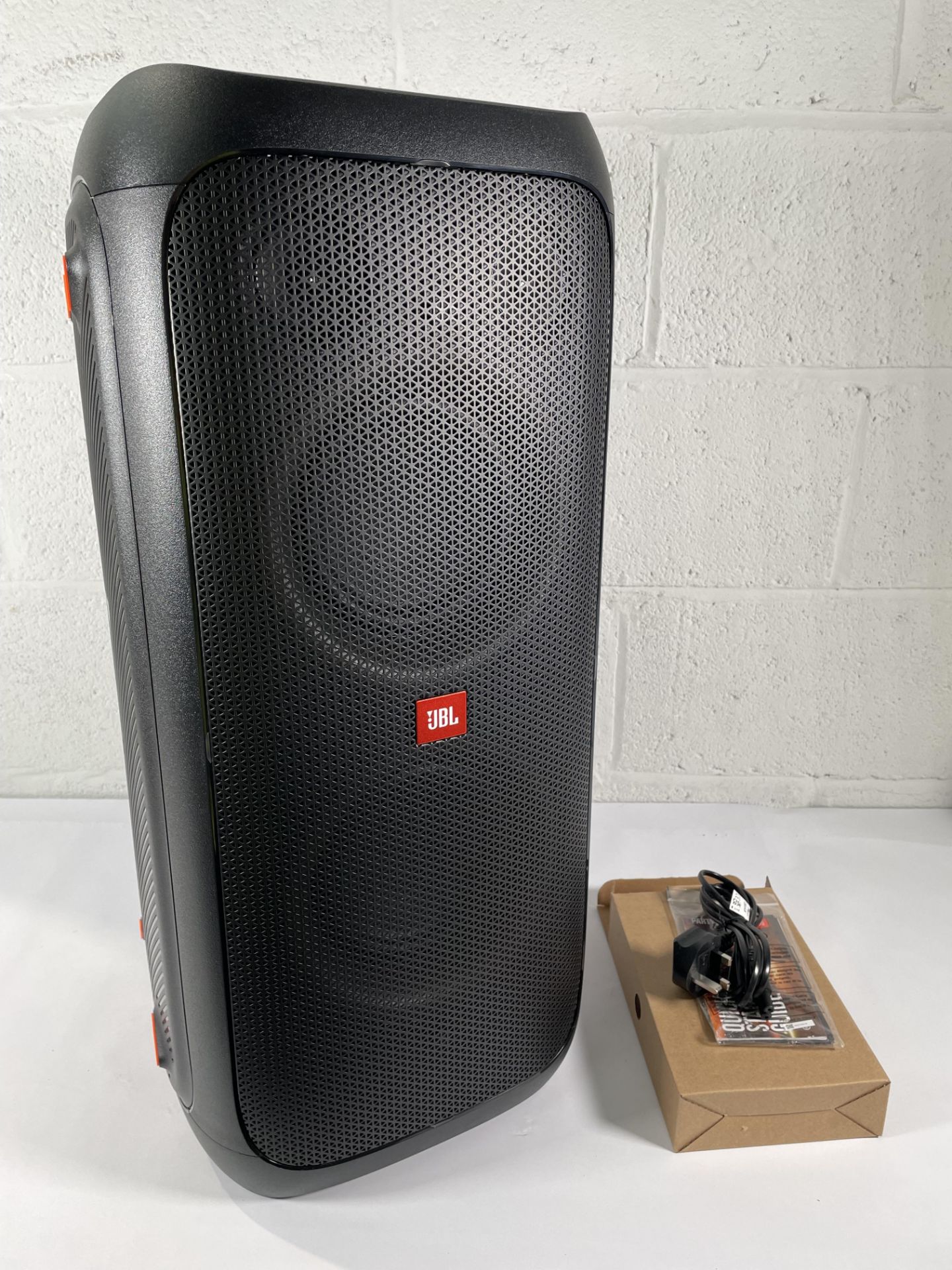 A JBL Partybox 310 (with box and packaging).