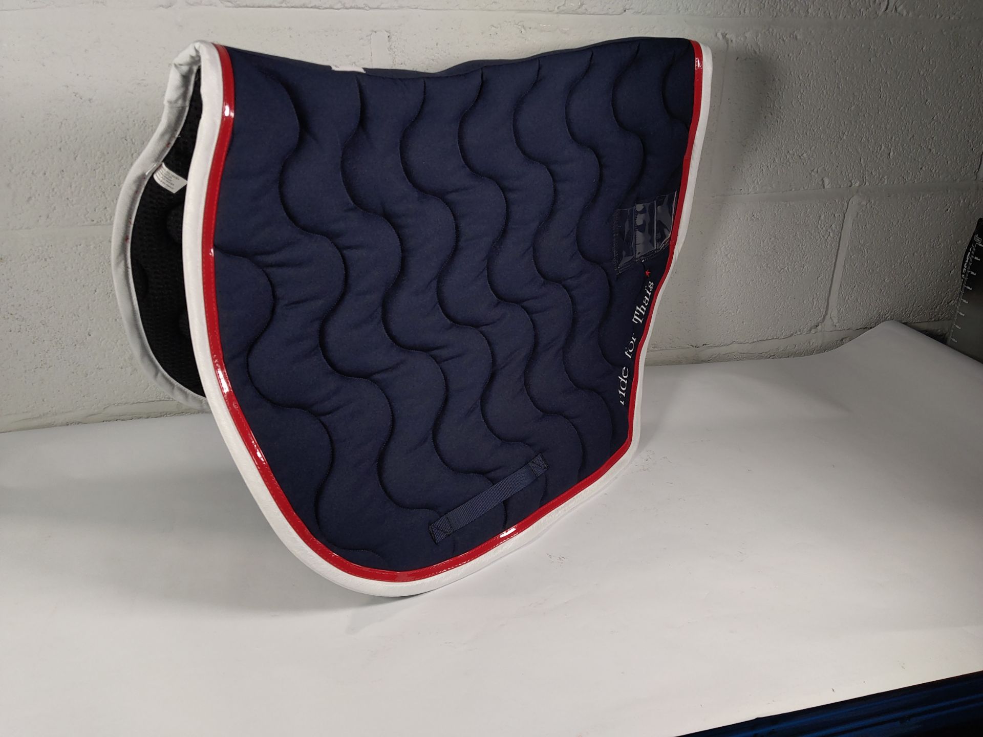 Three assorted pre-owned Paddock Sports 'Ride For Thais' Saddle Pads.