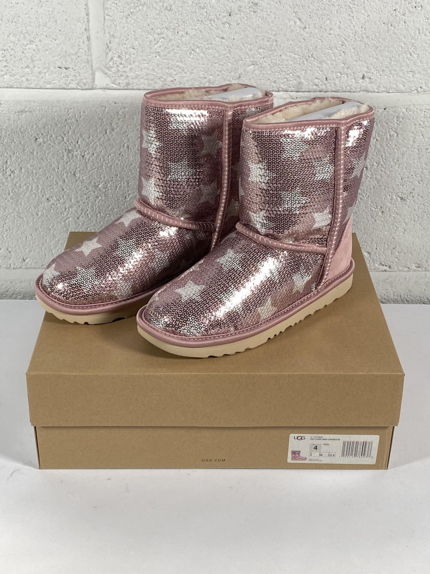 A pair of children's Ugg classic short 2 sequin star boots (UK 3).