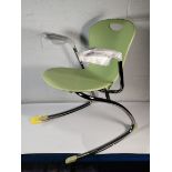 An as new Zuma Rocker chair with arms, Colour: Apple.