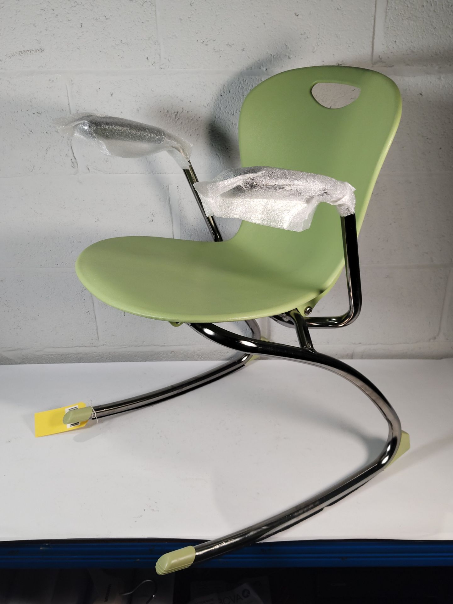 An as new Zuma Rocker chair with arms, Colour: Apple.