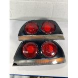 A pair of Nissan Skyline R33 taillights (requires repairing and repainting).