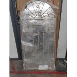 An as new Somerley gothic arch stone coloured garden mirror 140cm x 65cm.