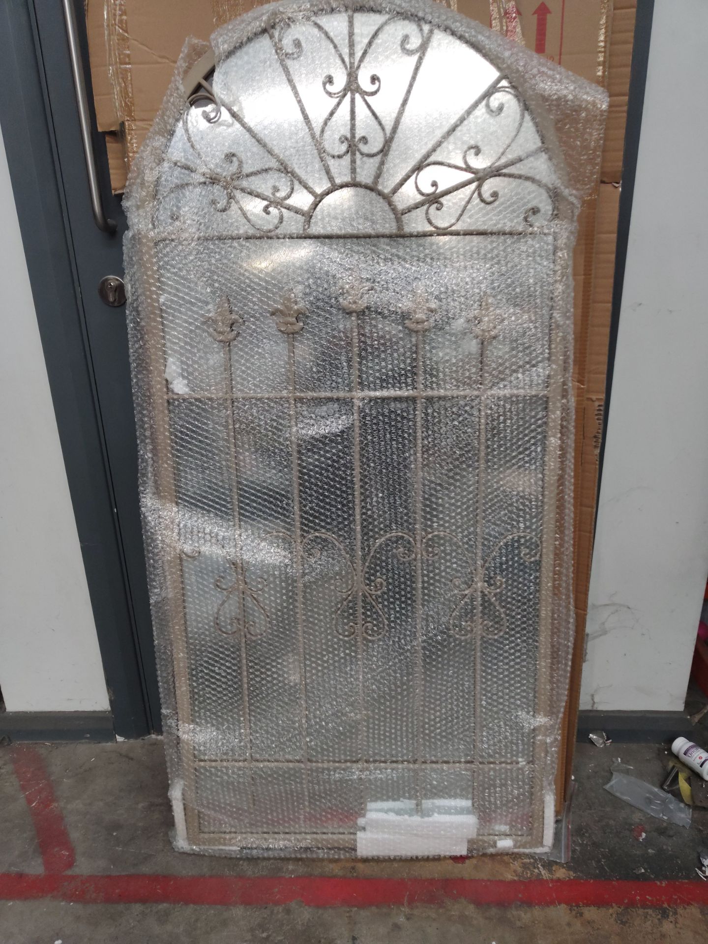 An as new Somerley gothic arch stone coloured garden mirror 140cm x 65cm.