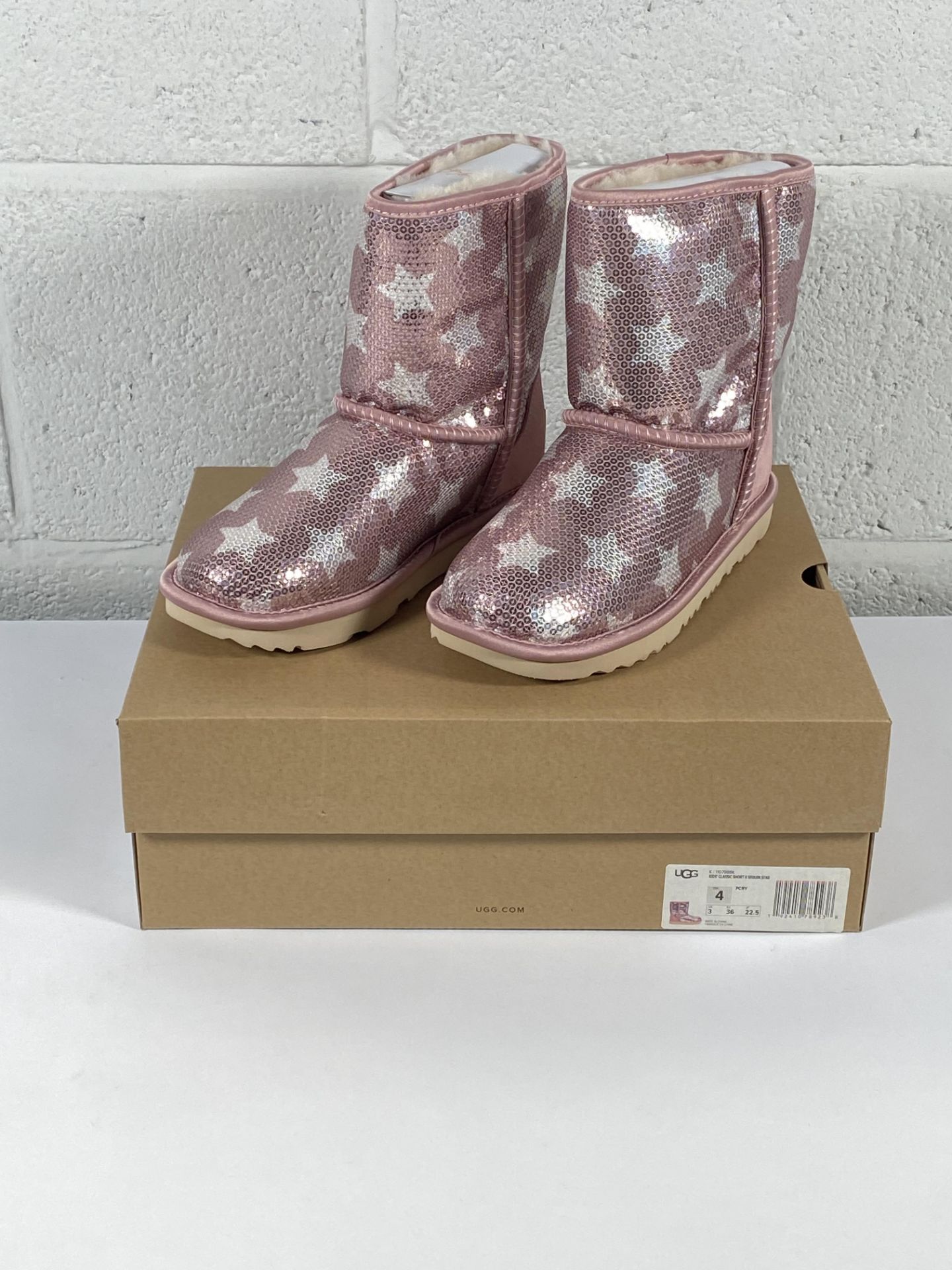 A pair of children's Ugg Classic Short 2 sequin star boots (UK 3).