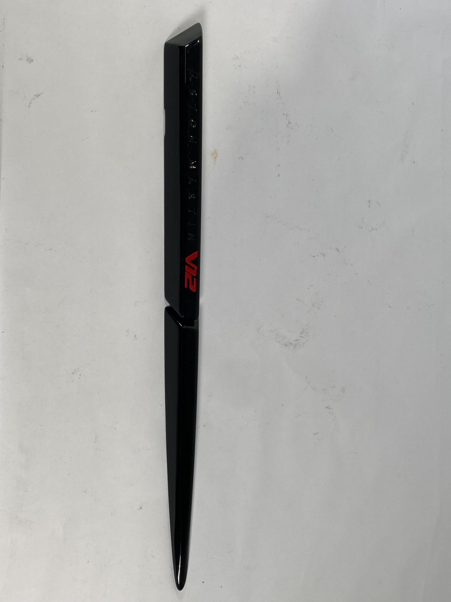 A gloss black left hand side strake assembly kit for a 2025 Aston Martin Vanquish Super GT V12.