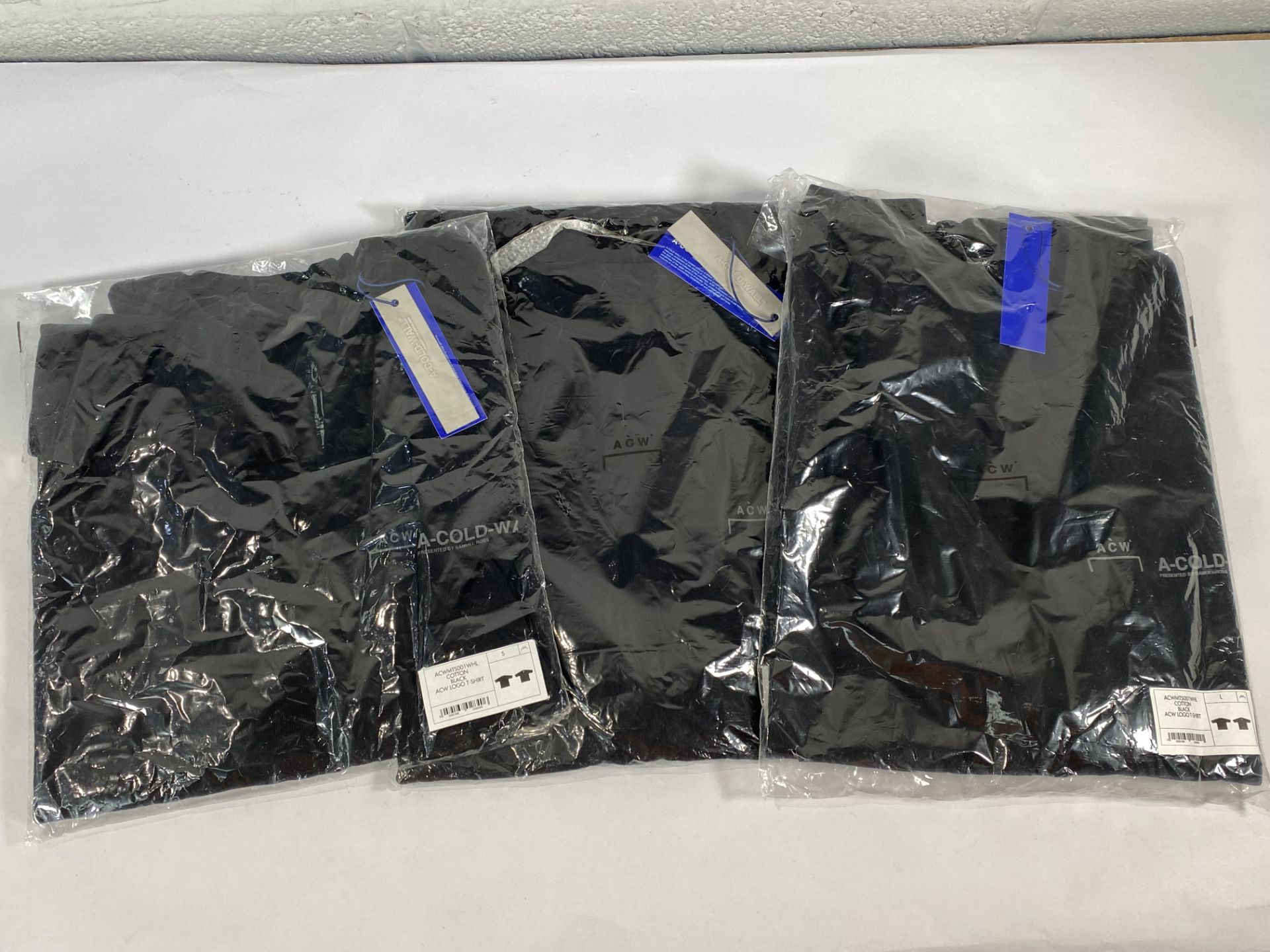 Three A-Cold wall logo t-shirts (1x S and 2x L).
