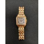 An 18ct gold Cartier wristwatch with square gold case, fitted with an 18ct gold link bracelet.