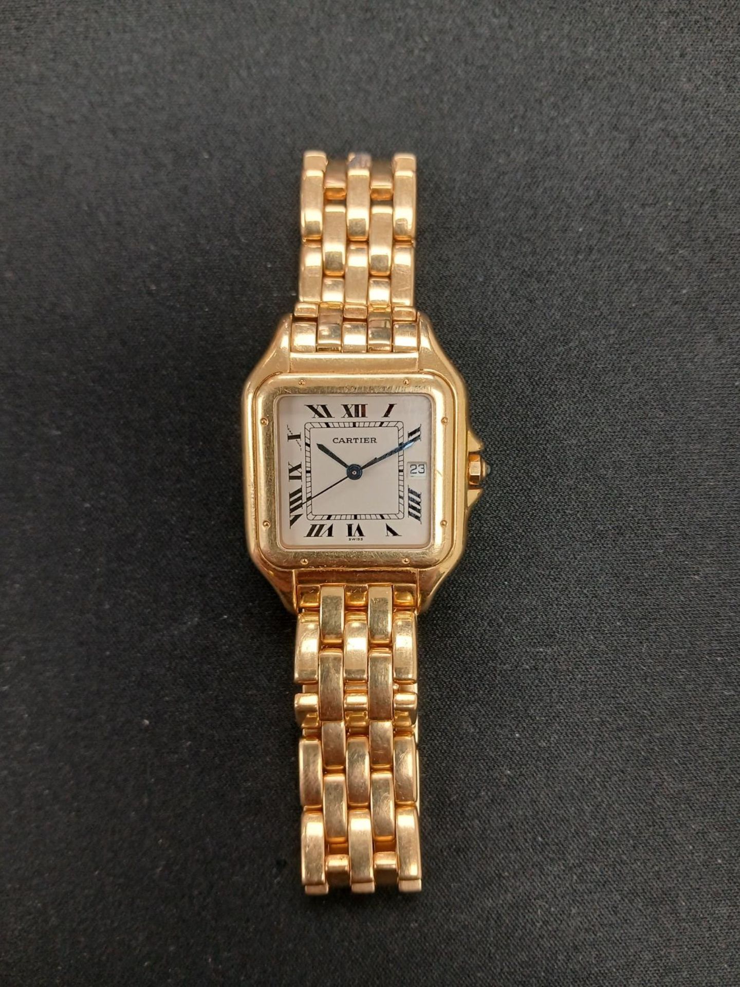An 18ct gold Cartier wristwatch with square gold case, fitted with an 18ct gold link bracelet.