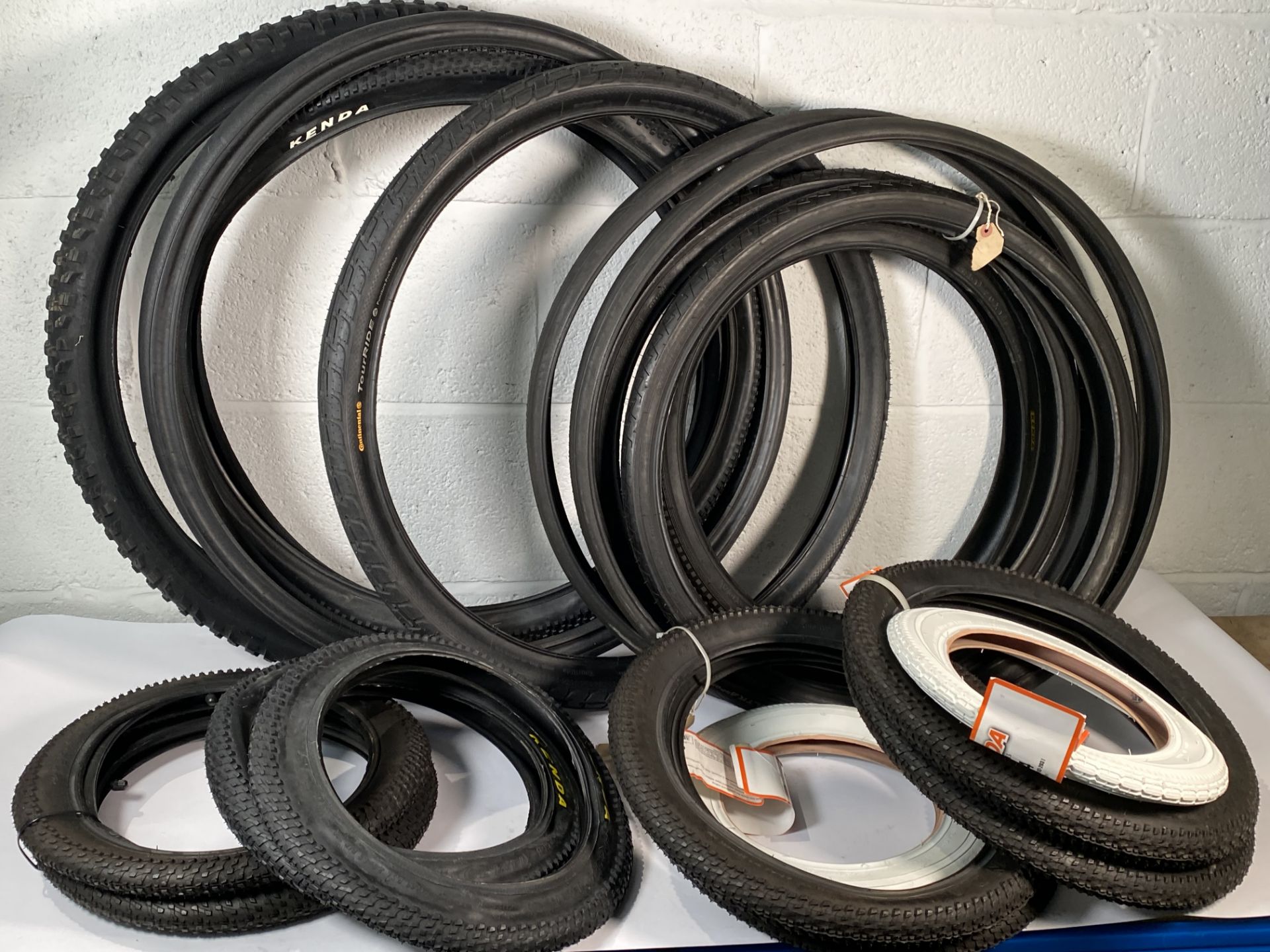 Nineteen as new and pre-owned adults and kids bike tyres to include Kenda, Continental, Bontrager.
