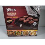 A pre-owned NINJA Sizzle Grill Flat Plate, Low Smoke.