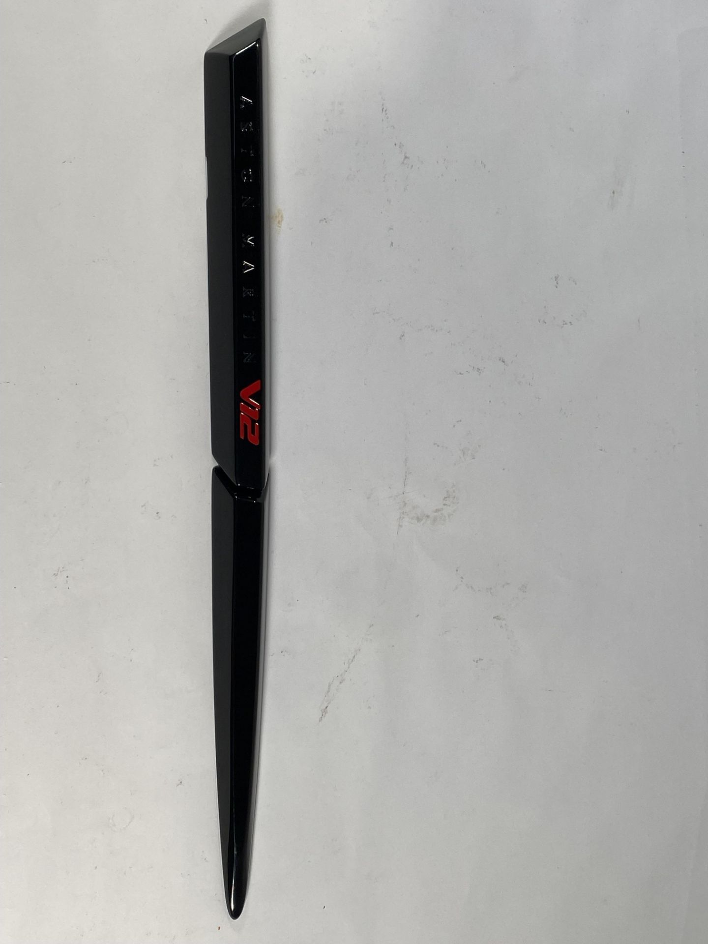 A gloss black left hand side strake assembly kit for a 2025 Aston Martin Vanquish Super GT V12.