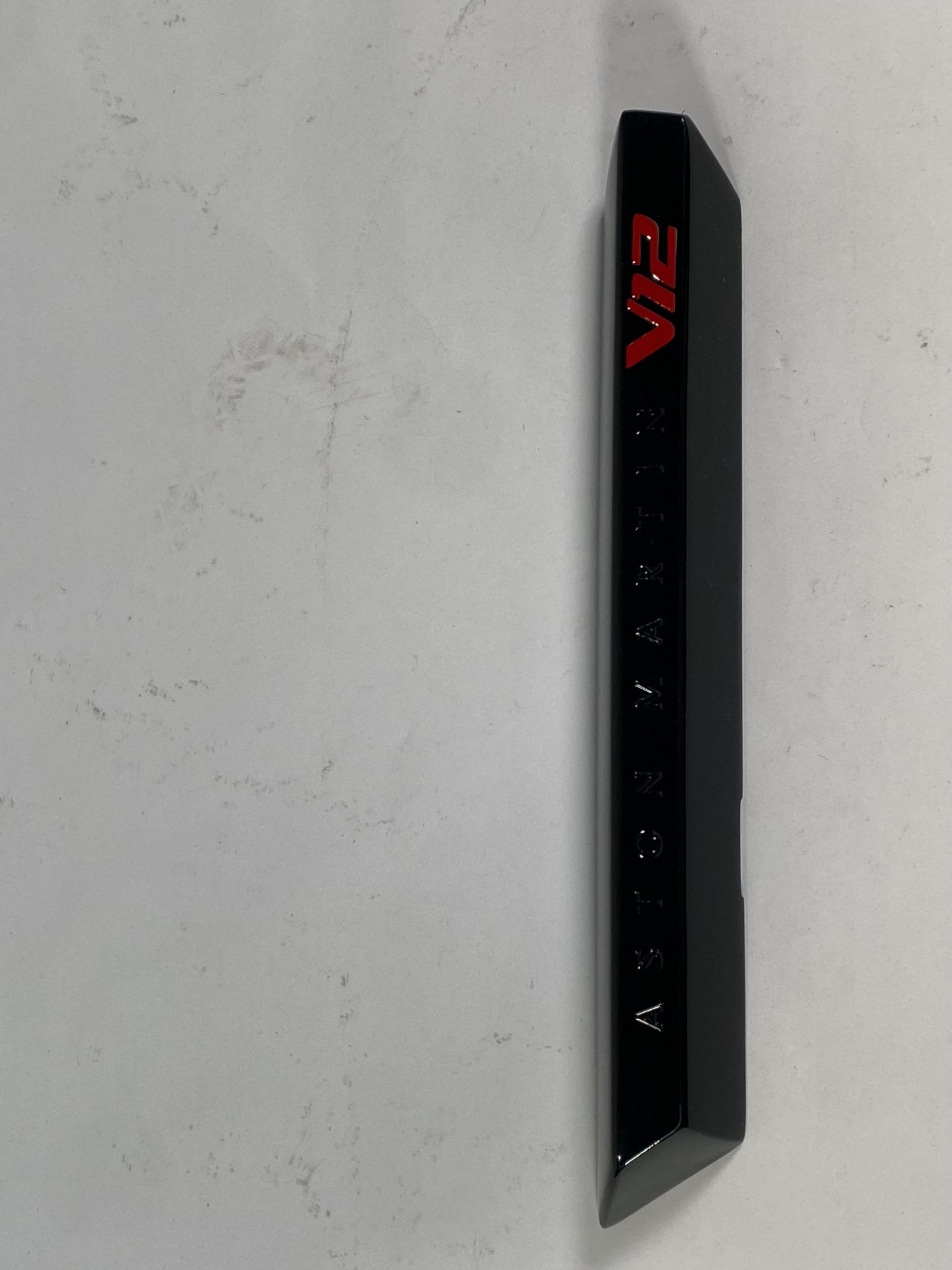 A gloss black left hand side strake assembly kit for a 2025 Aston Martin Vanquish Super GT V12.