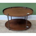An oval two tier side table with brass gallery, 65x44x38cmH