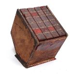 A magazine rack modelled as four large leatherbound books (af), 25.5cmW