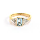 An 18ct gold, aquamarine and diamond ring, the emerald cut aquamarine approx. 0.63ct, flanked by