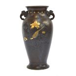 A Japanese Meiji era twin handled bronze vase with mixed metal inlay decoration depicting a finch