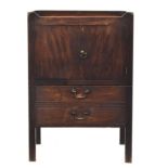 A George III mahogany tray top commode, with cutout carry handles, over a pair of cupboard doors,