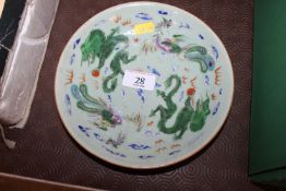 A Chinese celadon ground dragon decorated shallow