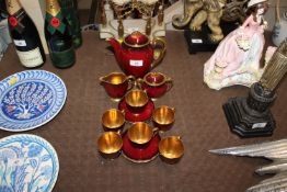A Carlton ware red and gilt decorated coffee set